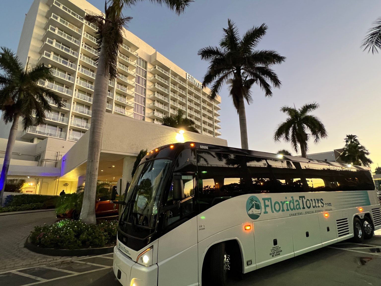 A motorcoach waiting at the hotel entrance